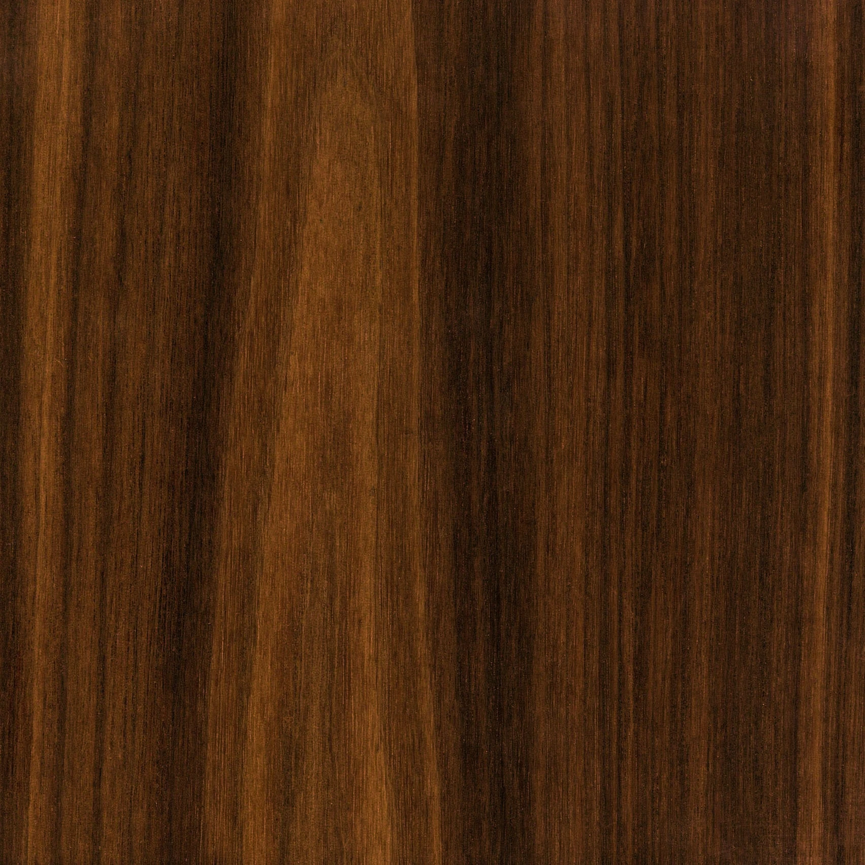 A close-up of a wooden surface with a rich, dark brown color. The texture displays a natural grain pattern with subtle variations in shade, giving it a warm and polished appearance. The surface is smooth and has a glossy finish.