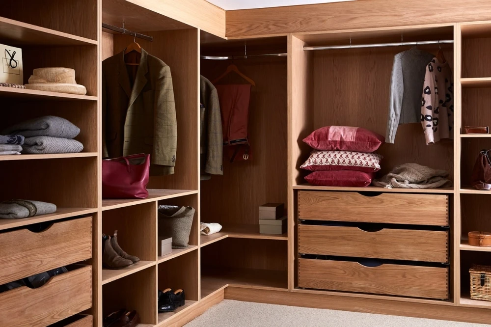 Interior view of a roomy and practical walk in wardrobe used for dressing and storage.