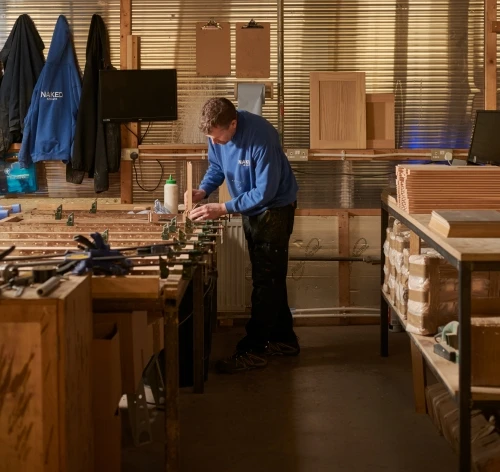 Worker building kitchen cabinets