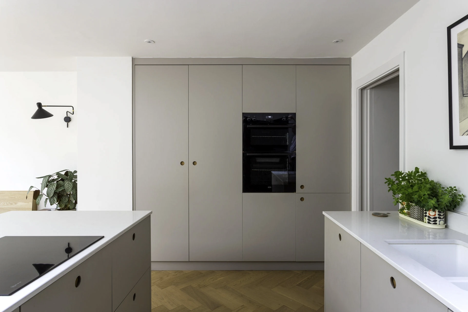 A warm and inviting Camberwell kitchen with exposed dove grey fronts, exuding an effortless chic aesthetic that invites creativity and culinary adventures.