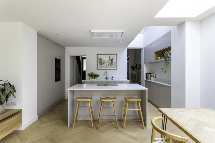 A charming corner of the Camberwell kitchen, featuring a sleek island with a dove grey surface and a complementary pendant light, creating a focal point for culinary creation and shared meals.