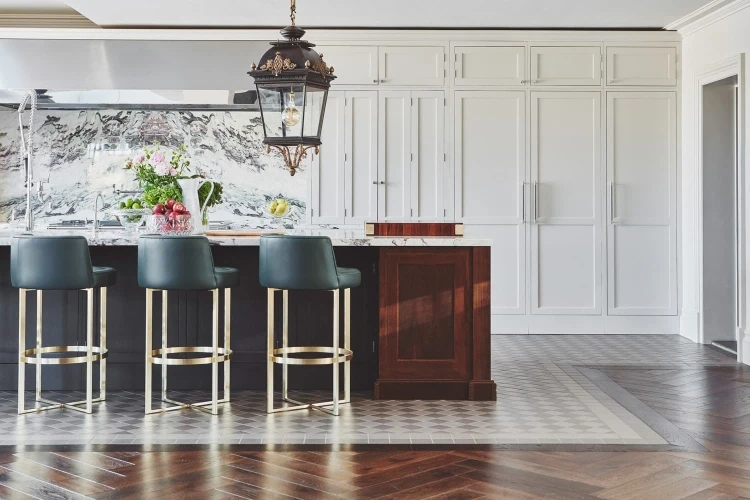 Elegant Chester Row kitchen featuring classic shaker cabinets, luxurious marble worktops, and bespoke touches. The walnut island serves as a focal point, while brass and stainless steel accents add a touch of luxury.