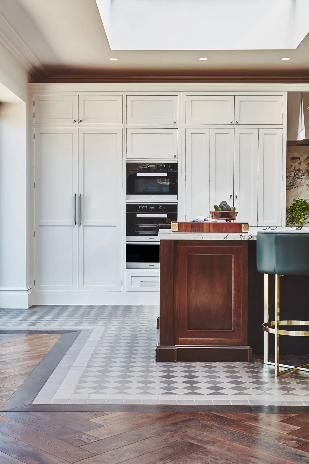 Walnut butcher's block in the Chester Row kitchen, providing a substantial work surface for preparing and chopping ingredients. The butcher's block complements the elegant marble worktops and exudes a sense of rustic charm.