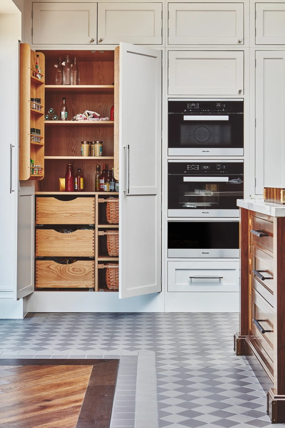 Spacious Chester Row kitchen with a double larder providing ample storage. The larder features drawer boxes and baskets for organising items and maximising storage efficiency.