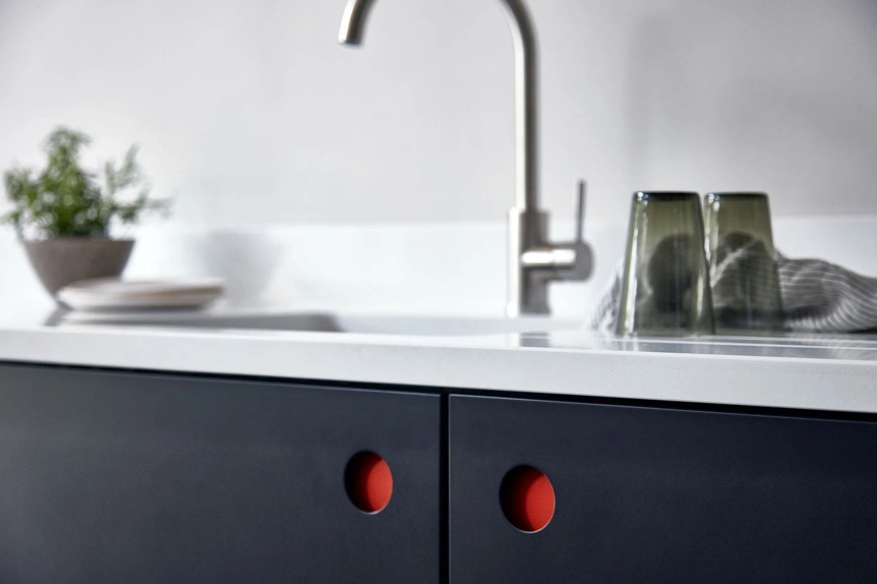 Discover a one-of-a-kind Ladbroke kitchen, featuring bold and funky pops of colour with the combination of dark blue doors and red handles.