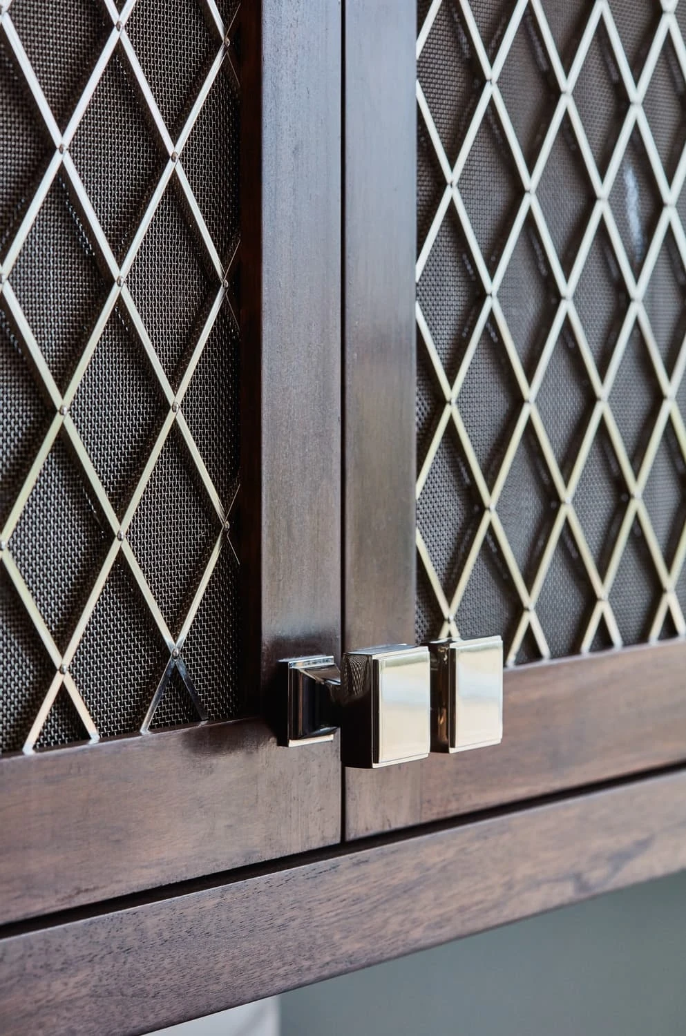 A detailed view of the Georgian Hall kitchen's cabinets reveals the intricate grain of the walnut wood, adding depth and character to the overall design