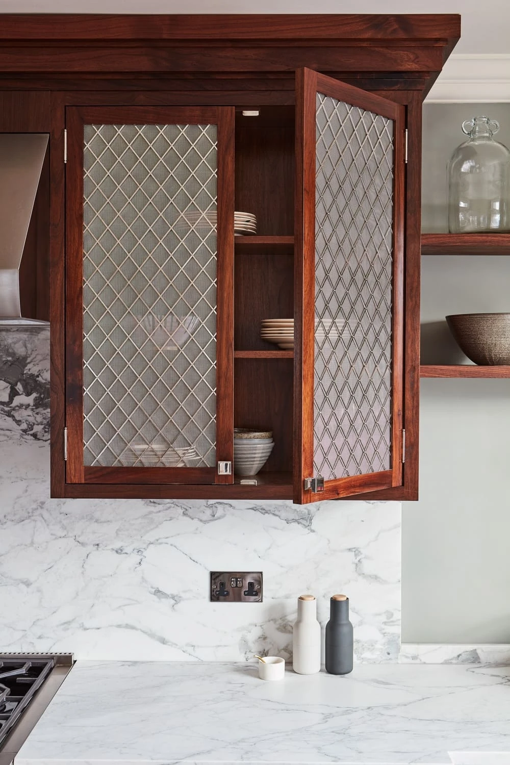 A detailed view of the Georgian Hall kitchen's cabinets reveals the intricate grain of the walnut wood, adding depth and character to the overall design.