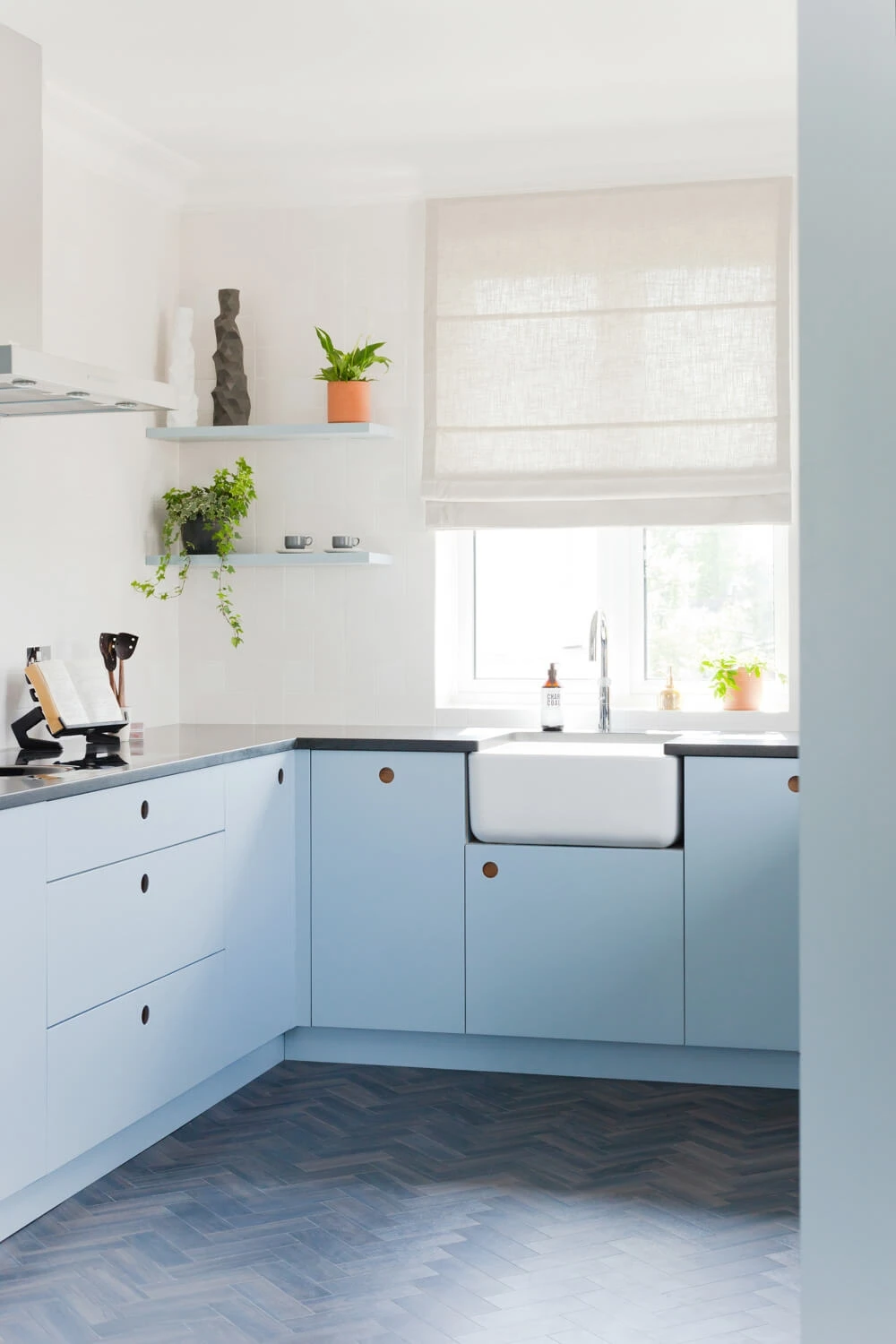 Grain-visible cabinetry and a perfectly centered window highlight the beauty of natural textures.