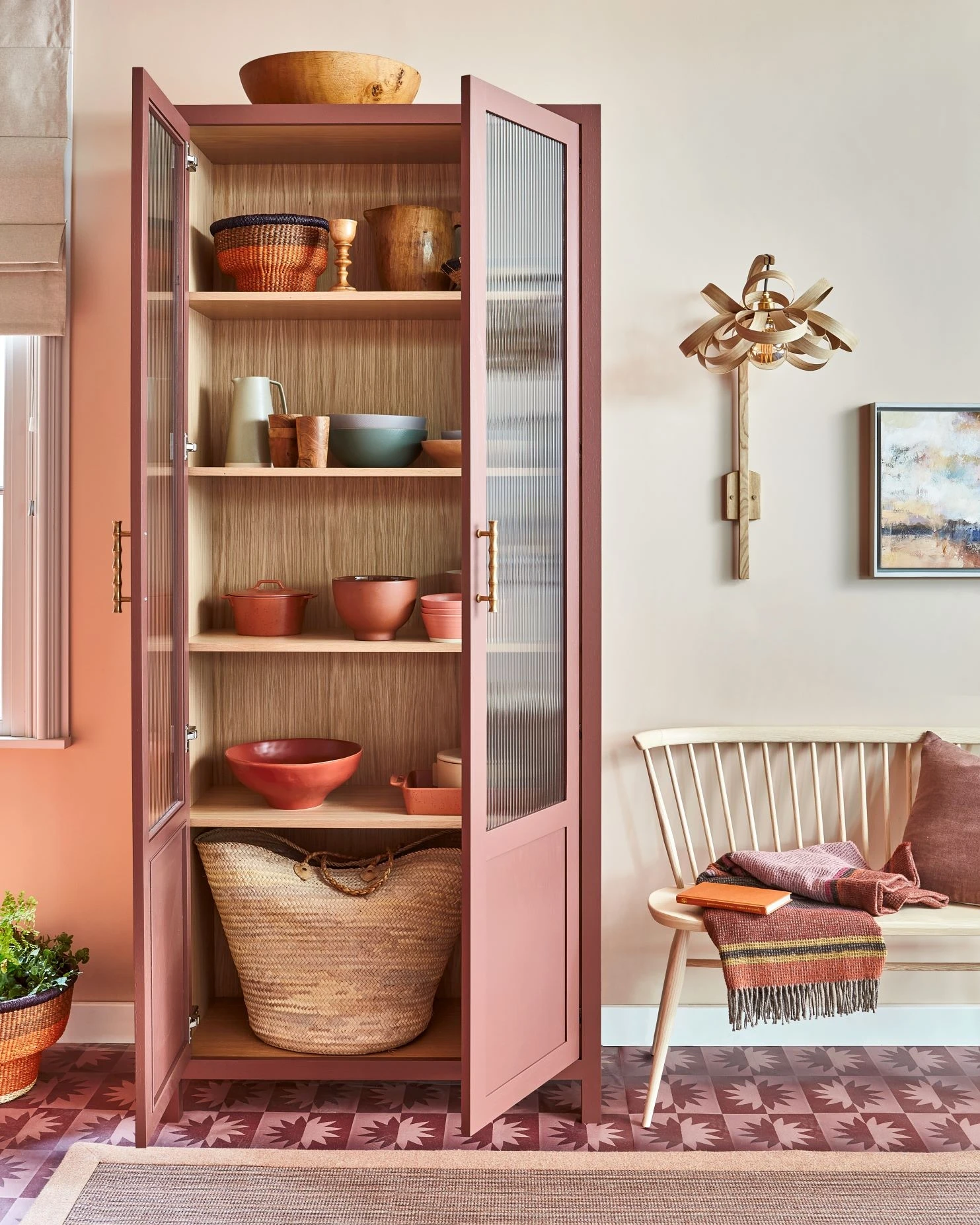 Step into a world of refined storage and impeccable presentation with this stylish and functional free-standing pantry/display cabinet. Adored with reeded glass and elegant brass handles, this cabinet provides ample space for culinary essentials, showcasing the kitchen's attention to detail and functionality.