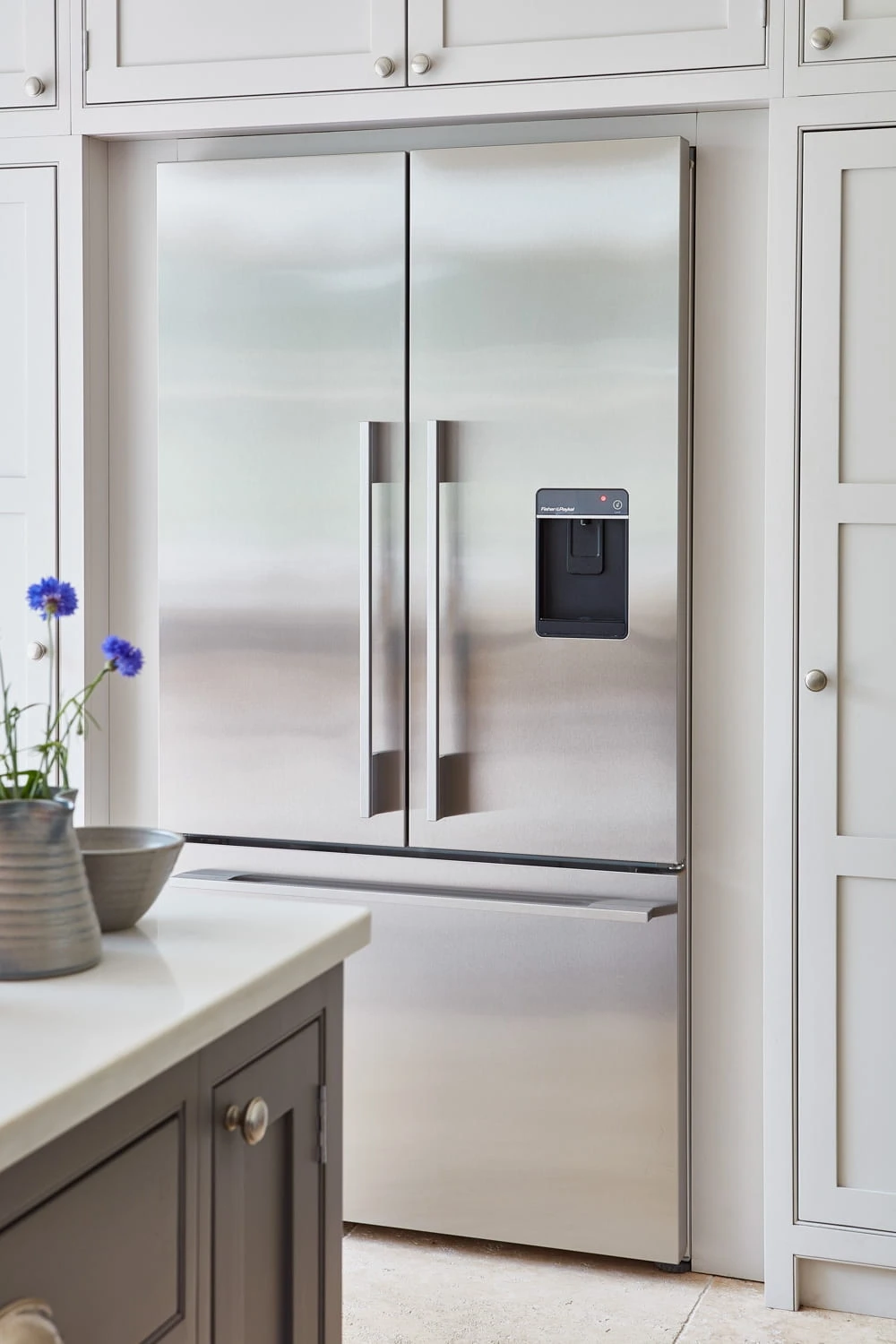 Eye catching modern appliance surrounded by beautiful shaker cabinetry.