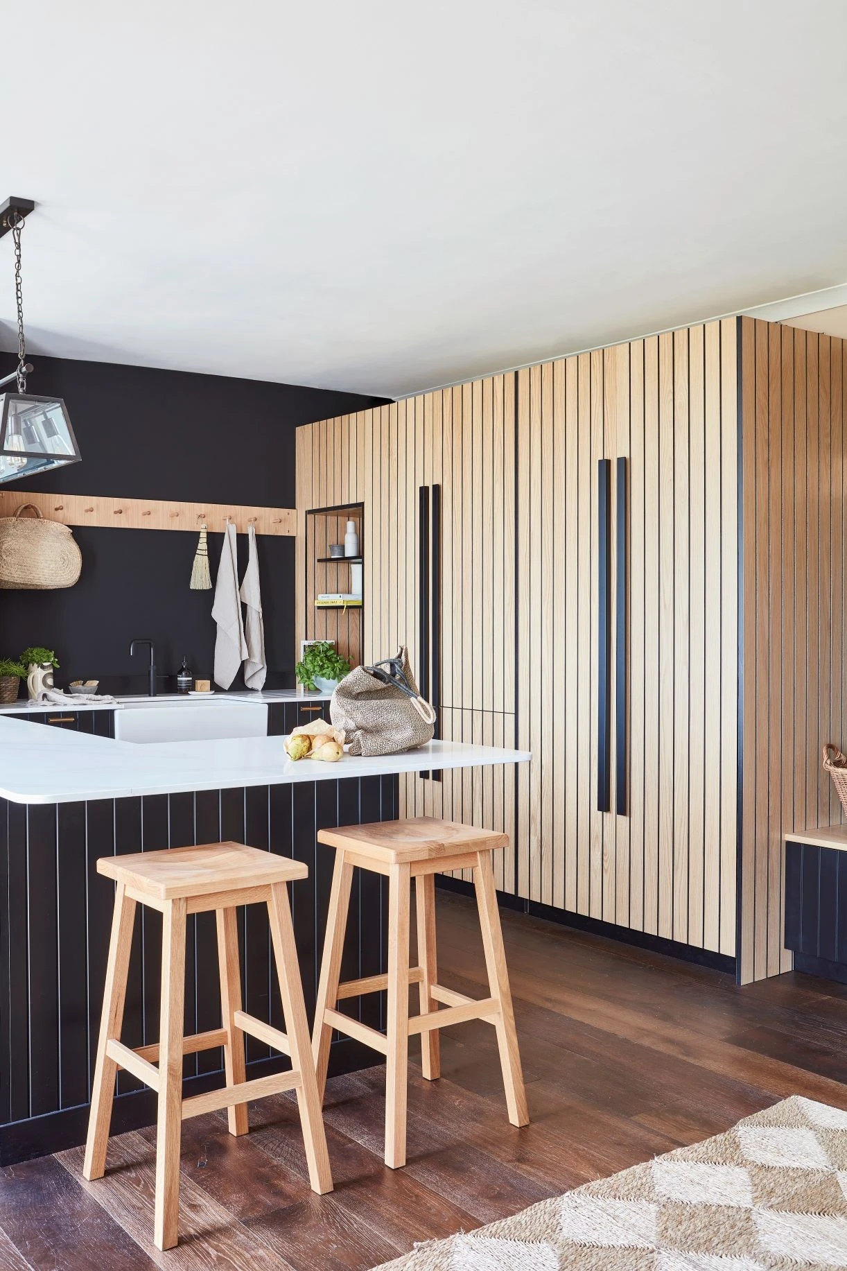 Ample storage solutions in the Kitchen, including stacked washing machine and dryer units neatly hidden behind pocket doors, maximising space utilisation.