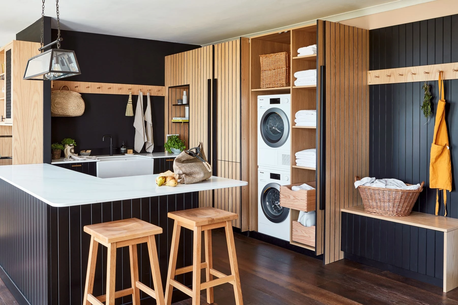 Stylish Kitchen seamlessly integrated with the bar area, both featuring distinctive oak black core cabinets and black granite countertops, creating a sophisticated and functional space.