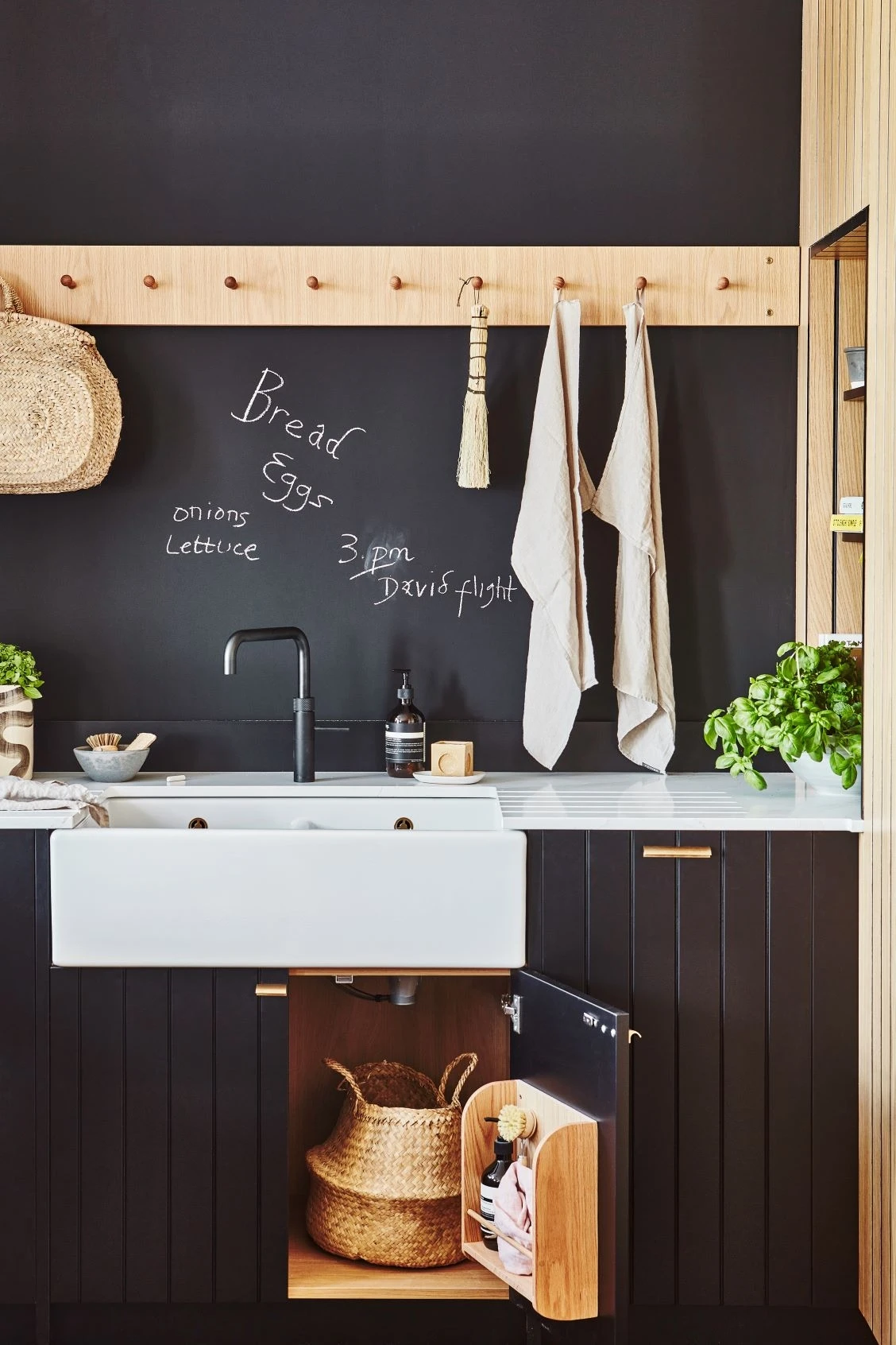 Detailed view of the Kitchen's blackboard-painted back wall, providing a versatile surface for creative expression and task management.