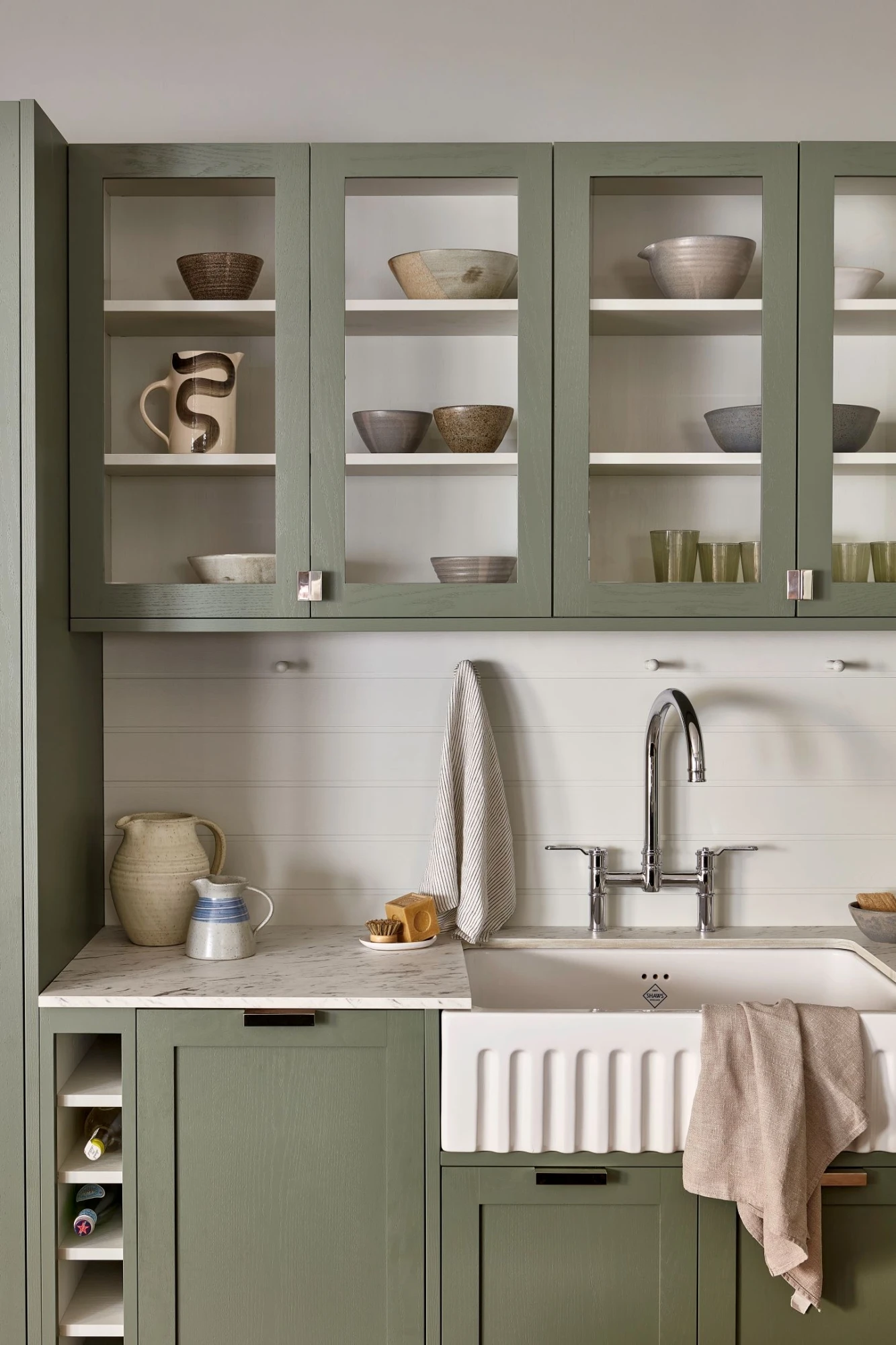 A captivating close-up of the kitchen's exquisite cabinetry, showcasing the harmonious blend of three captivating green tones. The cabinets boast subtle graining and elegant hardware accents, adding a touch of refinement to the space. 