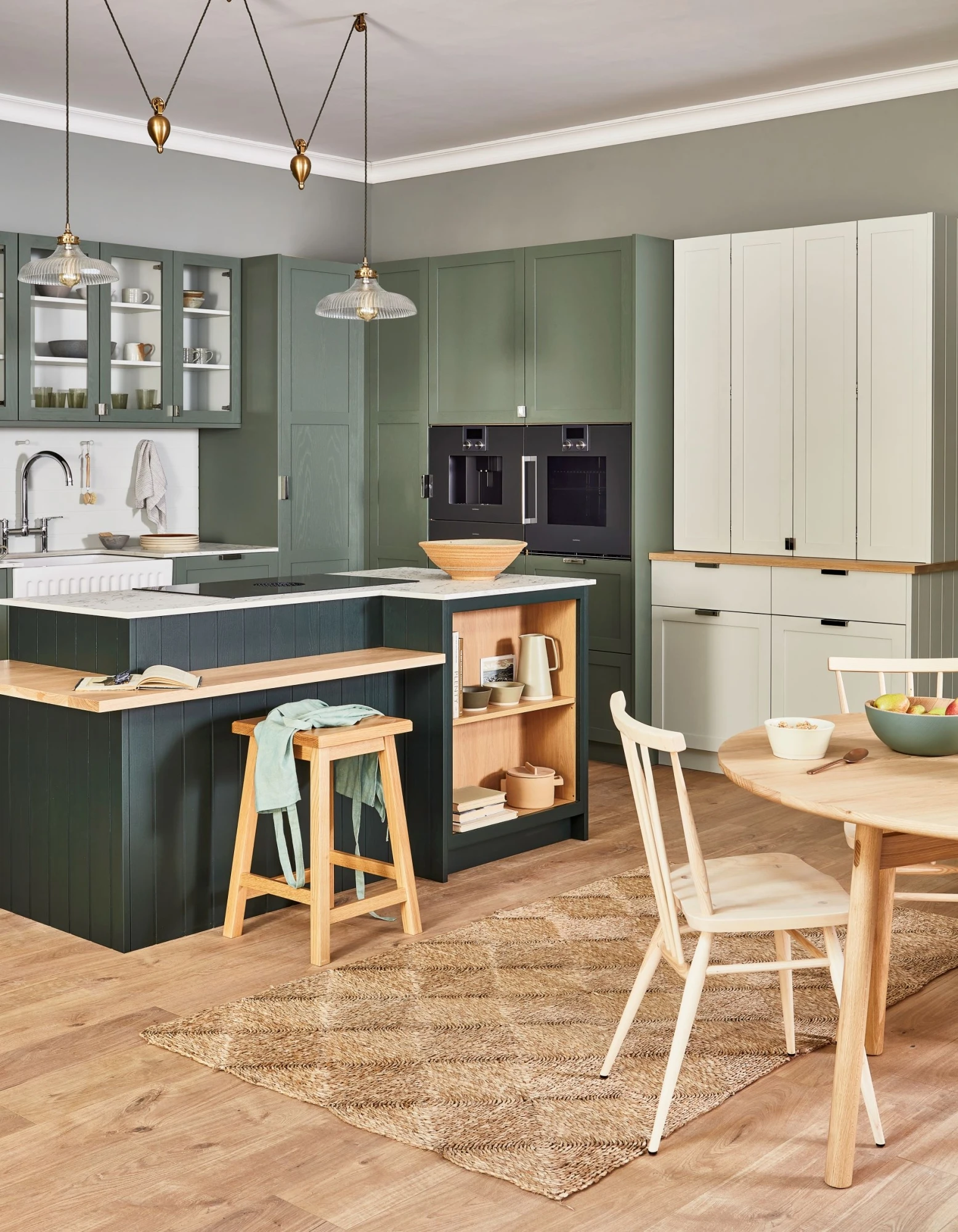 A mesmerizing view of the kitchen's sleek and stylish breakfast bar, crafted from warm oak wood. The bar provides ample seating and serves as a convenient workspace, seamlessly blending into the overall design.