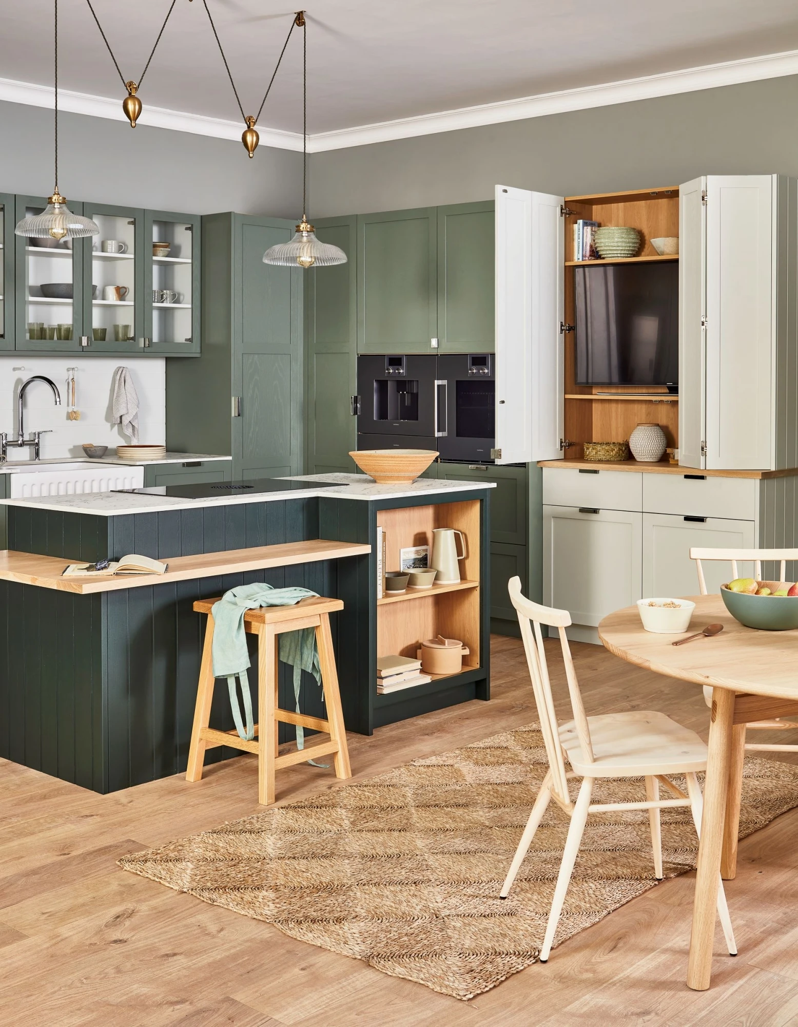 A mesmerizing view of the kitchen's sleek and stylish breakfast bar, crafted from warm oak wood. The bar provides ample seating and serves as a convenient workspace, seamlessly blending into the overall design. 