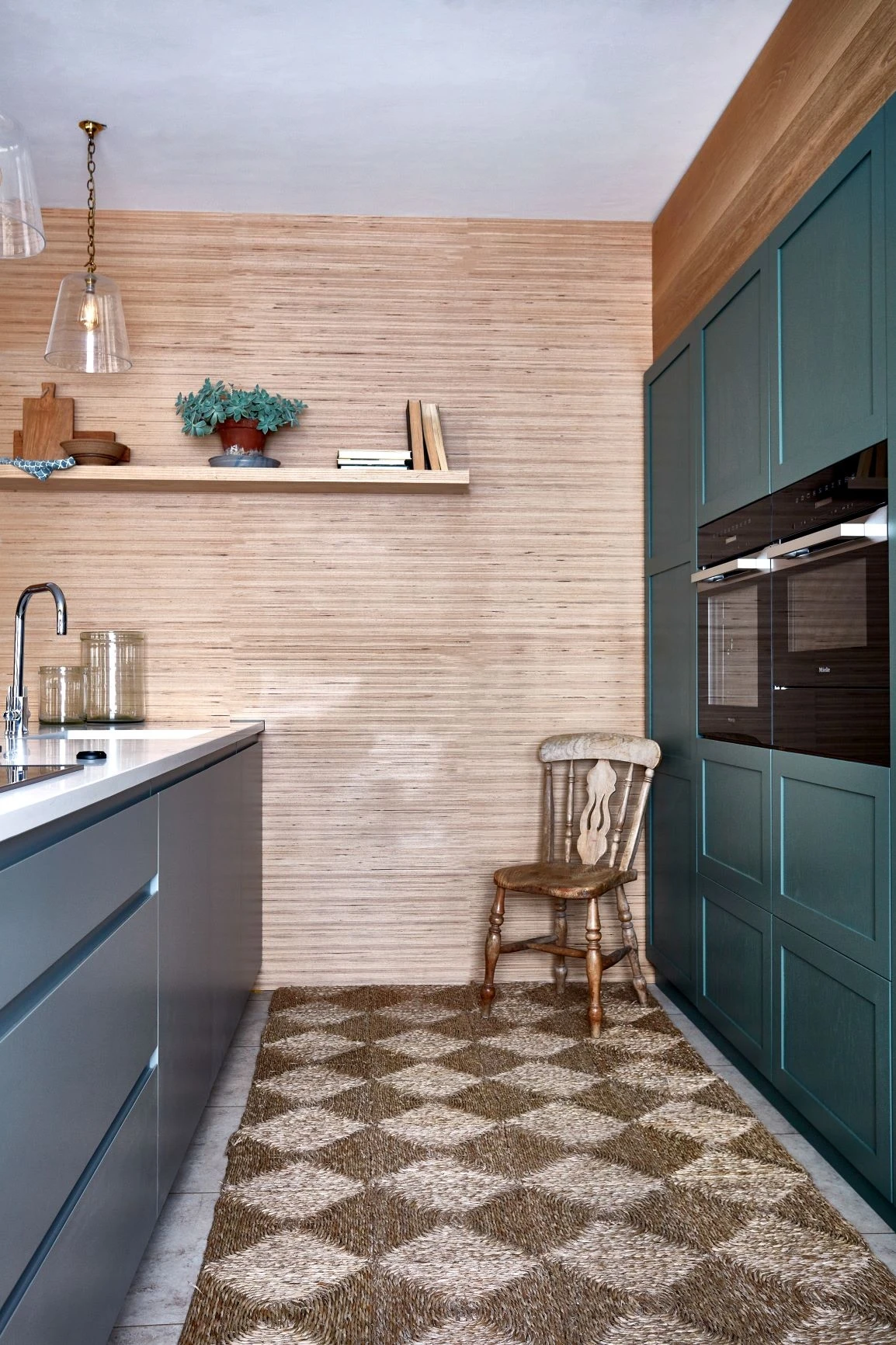 A glimpse into the stylish and inviting Stamford kitchen, featuring a bold combination of sage and dove grey hues. The continuous marble worktop adds a touch of elegance, while the eye-catching shaker cabinetry and handleless doors exude sophistication