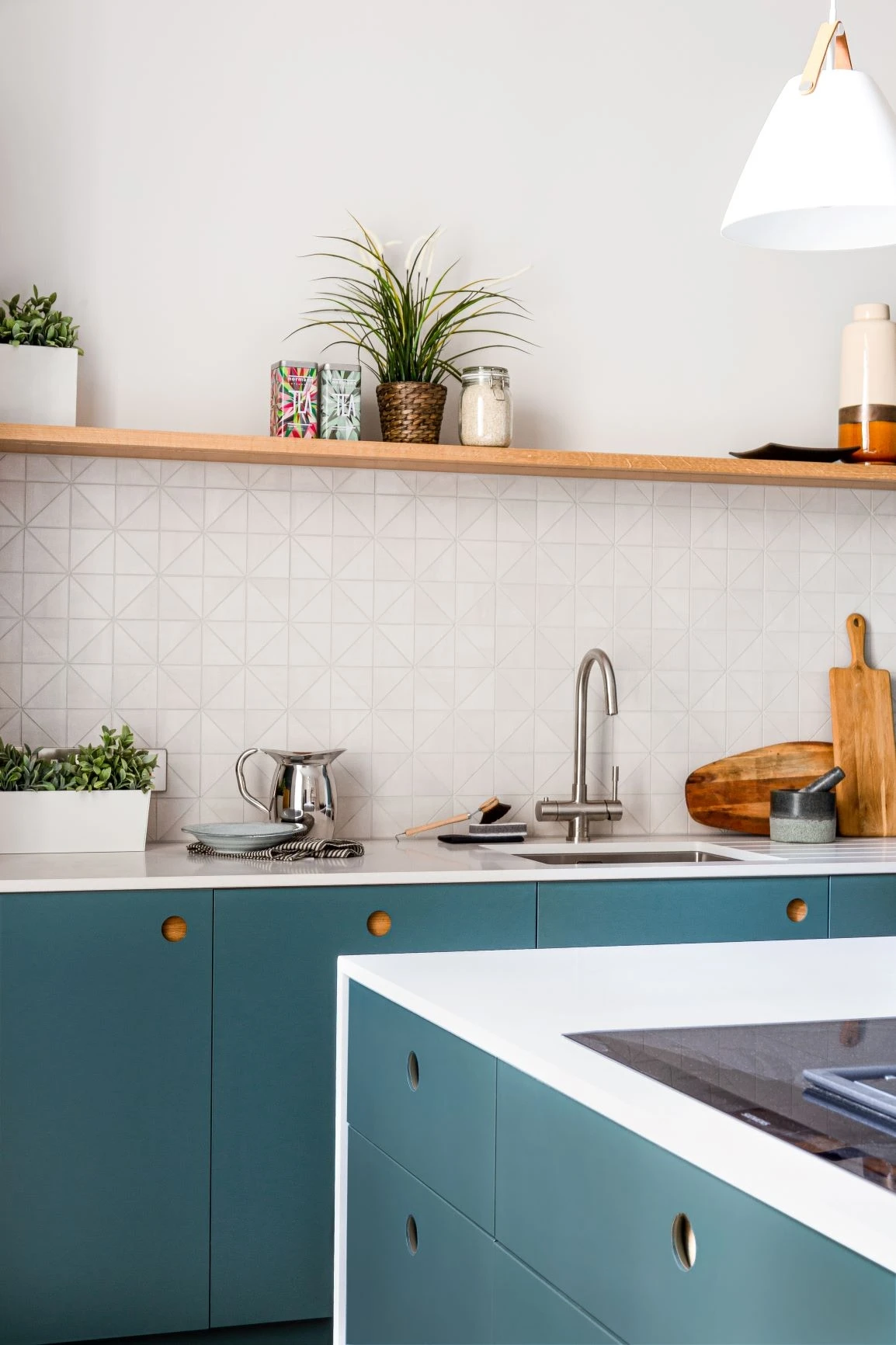 Brancaster Blue Ladbroke cabinets and a wrap-around quartz island make The Royal Mile kitchen perfect for entertaining, complete with oak detailing and chevron floors.