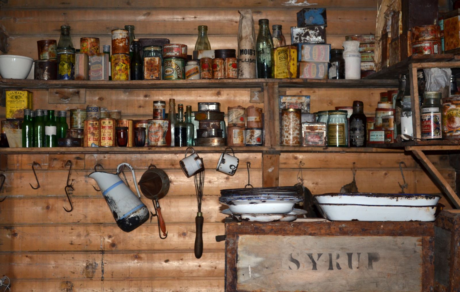 Storage shelves in Ernest Shackleton's Antarctic kitchen displaying food and supplies used on the mission,