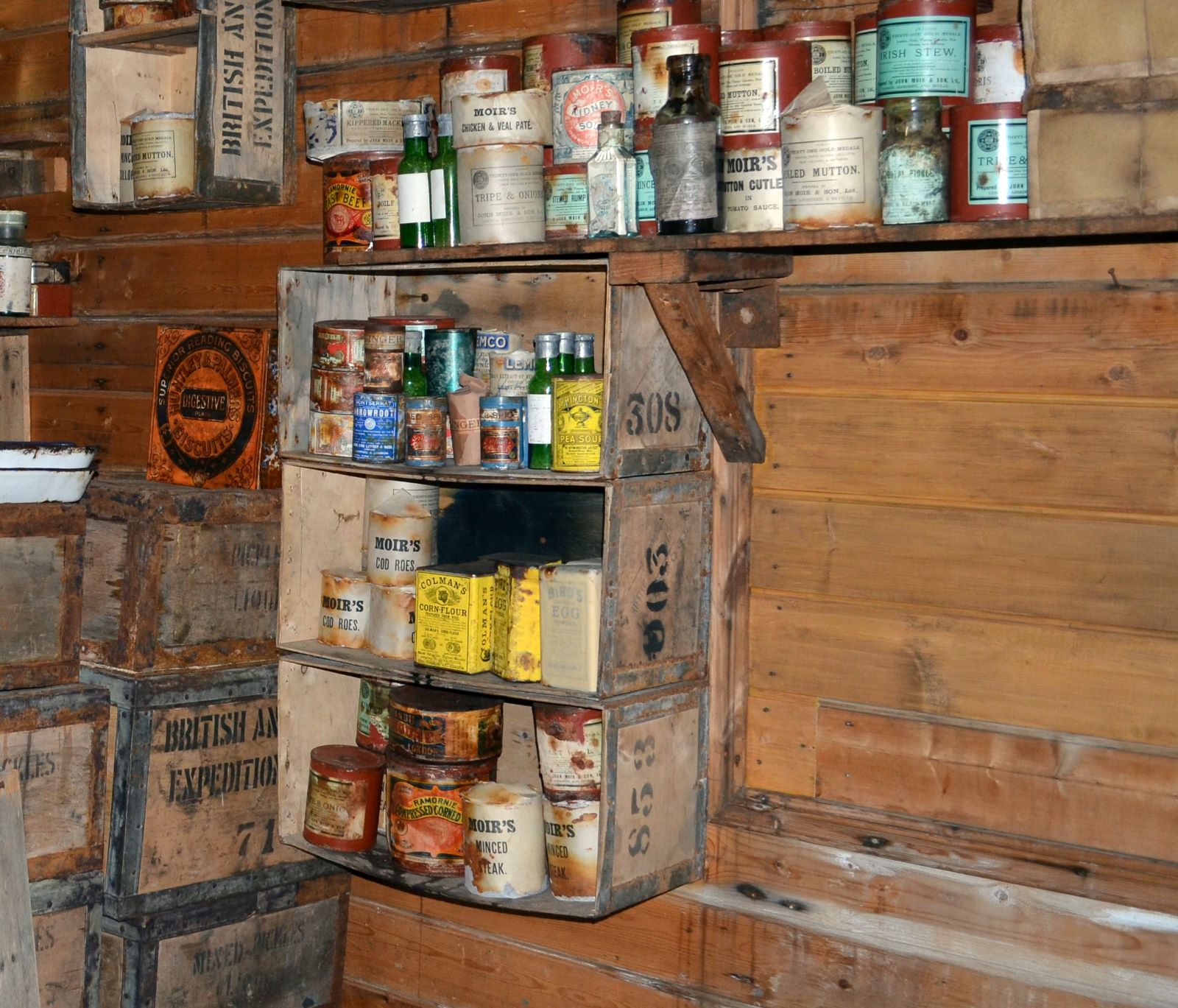 Storage shelves holding tinned goods within Ernest Shackleton's Antarctic kitchen,